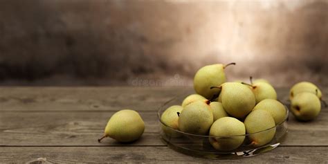 Green Pears In A Glass Bowl On Brown Wooden Table Stock Illustration Illustration Of Season