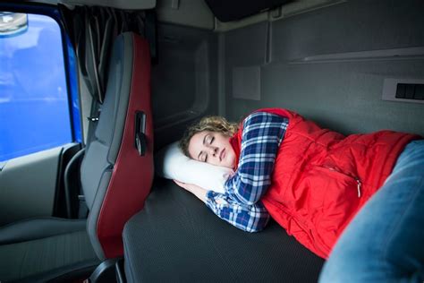 Free Photo Tired Truck Driver Sleeping In Cabin Of His Truck Due To