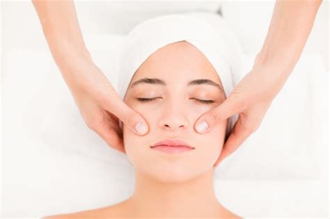 Premium Photo Attractive Woman Receiving Facial Massage At Spa Center