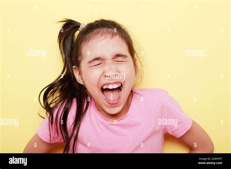 Portrait Of A Girl With A Scream Of Joy With Her Mouth Wide Open On A