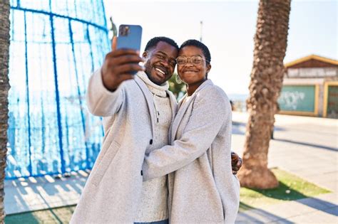 Man And Woman Couple Standing Together Make Selfie By The Smartphone At Street Stock Image