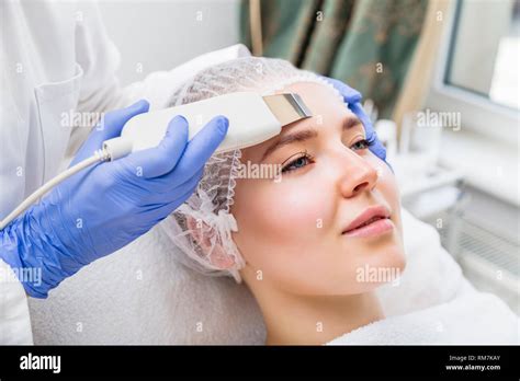 Cosmetologist Makes Ultrasound Cleaning Procedure In Salon Stock Photo