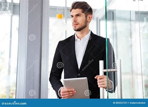 Businesman Holding Tablet And Entering The Door In Office Stock Image