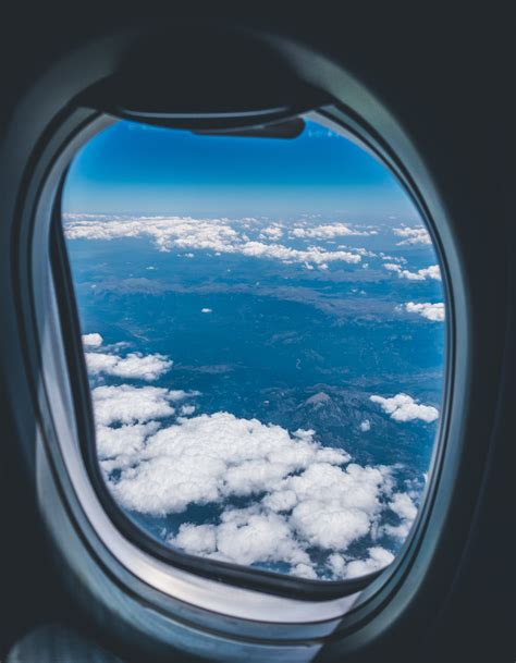 Airplane Window View Of White Clouds Over Mountain · Free Stock Photo
