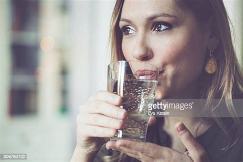 Woman Drinking Water In Kitchen Photos And Premium High Res Pictures