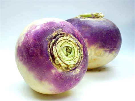 Root vegetable crops can often be planted as soon as the soil has warmed. Purple headed turnips on white ... | Stock image | Colourbox