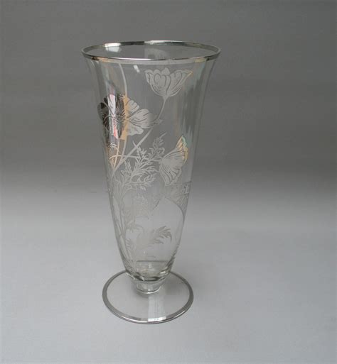 A Victorian Glass Vase Which Has An Overlay Of Silver Flowers