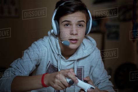 Teenage Boy With Headset Playing Video Game Stock Photo Dissolve