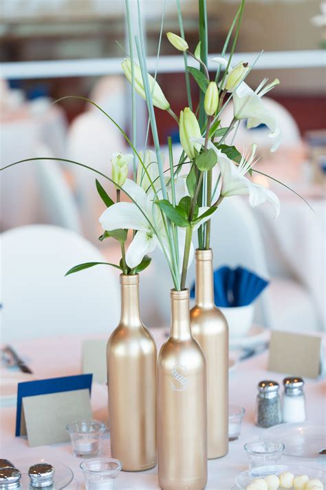 Join us this week as we create this tall glam gold wedding centerpiece! DIY Gold Bottle Centerpieces with Asiatic Lilies
