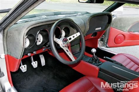 The Interior Of A Car With Red And Black Leather