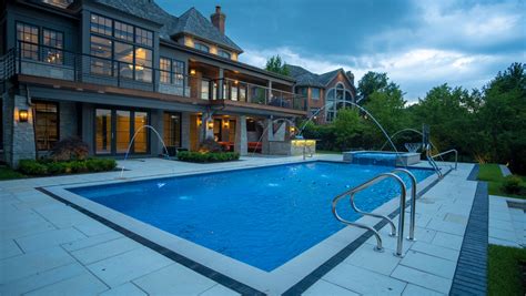 At night, leds cast a colorful glow on the water. Burr Ridge Lap Pool with Raised Hot Tub and Waterfall ...