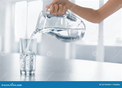 Drink Water Womans Hand Pouring Water From Pitcher Into A Glas Stock