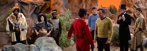 The Star Trek Crew Is Standing In Front Of Some Rock Formations And
