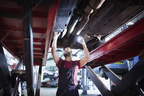 Male Mechanic With Flashlight Working Under Car Stock Image F031