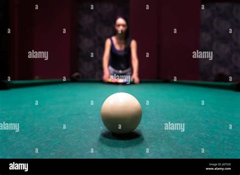Young Brunette Girl Puts Balls On The Billiard Table Big White Billiard Ball In The Foreground