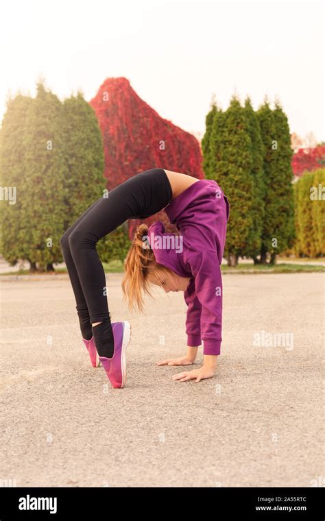 Outdoors Leisure Little Gymnast Doing Backbend Standing On Toes In The