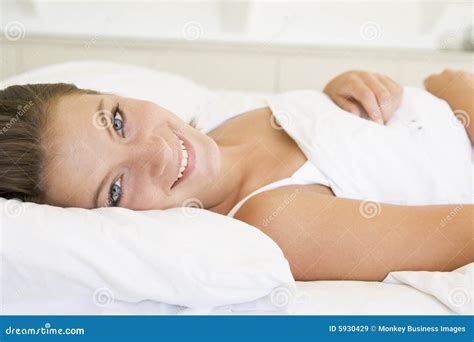 woman lying in bed smiling stock image image of bedroom 5930429