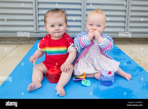 10 Month Old Babies Having A Snack And Drink Stock Photo Alamy