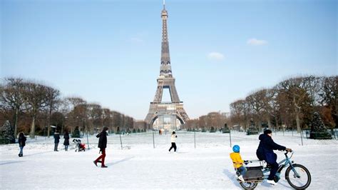 Eiffel Tower Workers Use Blowtorch To Clear Ice As Europe Cold Snap
