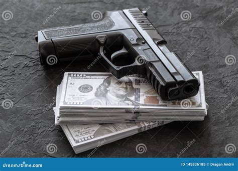 Pistol And Money Guns And Dollars On Black Background Stock Image