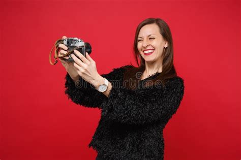 Funny Young Woman In Black Fur Sweater Doing Selfie Shot On Retro Vintage Photo Camera Isolated