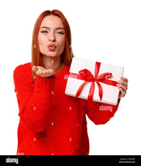 Young Woman In Red Sweater With Christmas T Blowing Kiss On White