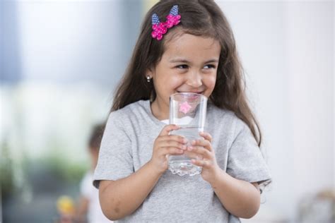 Smiling Cute Girl Holding Glass Of Water At Home Southeast Health