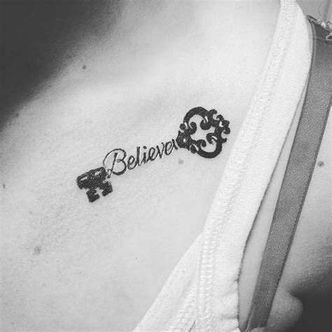 A Black And White Photo Of A Womans Chest With The Word Believe On It