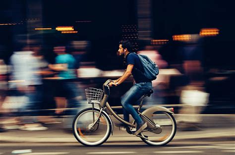 Man Riding Bicycle On City Street · Free Stock Photo