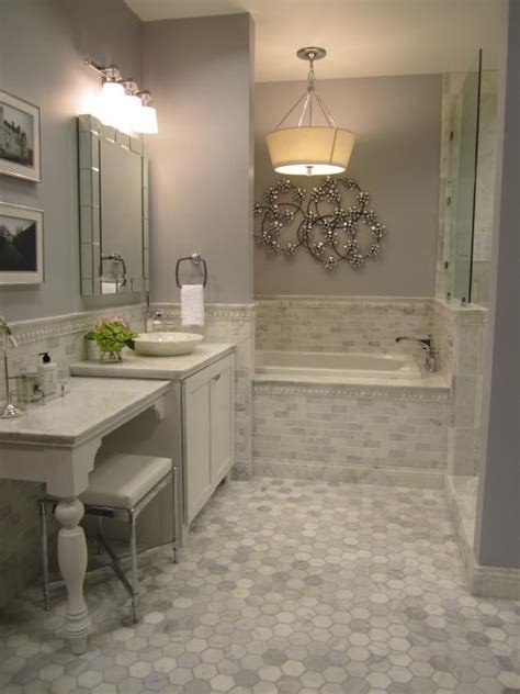 White bathroom floor tiles with small black insets can effectively ground the floor space, keeping it distinct from white walls. 29 gray and white bathroom tile ideas and pictures 2020