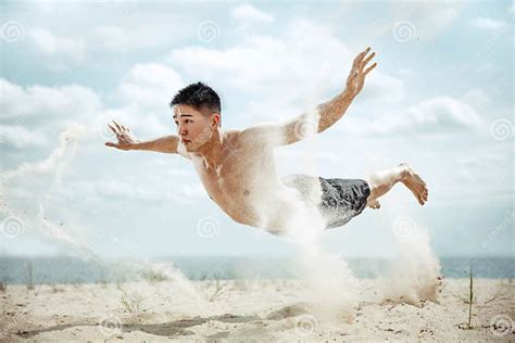 Young Healthy Man Athlete Doing Squats At The Beach Stock Image Image