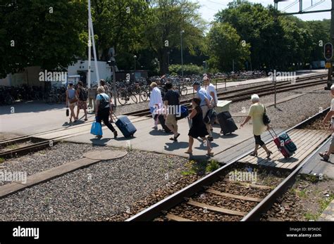 Rail Passengers Crossing Train Tracks At Swedish Station People On