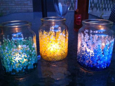 Three Jars Filled With Different Colored Confetti Sitting On A Table