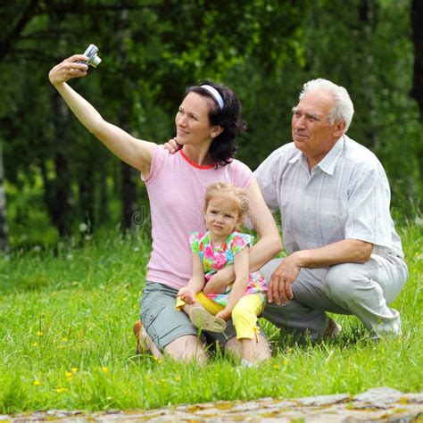 Grandfather Daughter And Granddaughter Are Photographed Outdoors