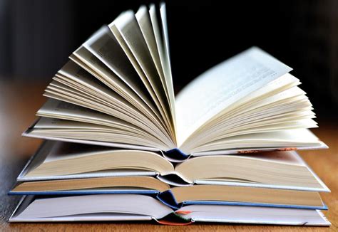 Four Open Books In Stack At Blur Background Free Image Download