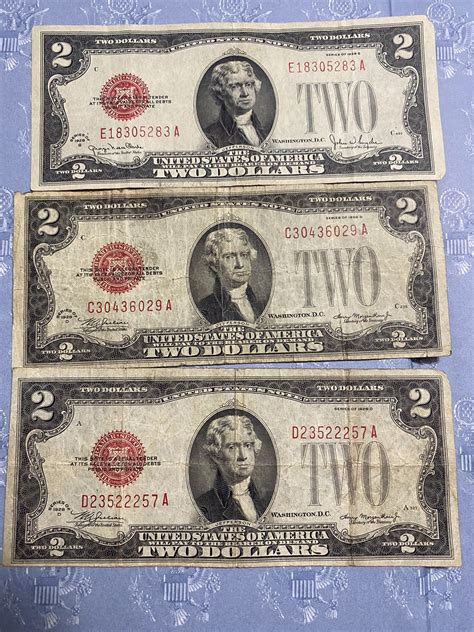 Seven red two dollar bills four bills are from 1953 and the other three