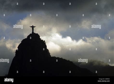 Christ The Redeemer Silhoutted Against The Clouds At Rio De Janeiro