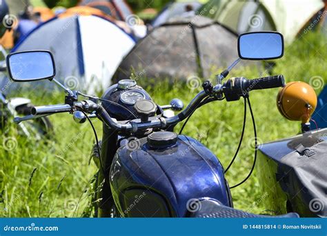 A Number Of Parked Motorcycles On The Green Grass At The Biker Festival