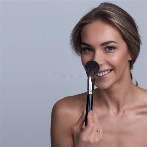 Portrait Of A Woman Holding A Makeup Brush Stock Photo Image Of