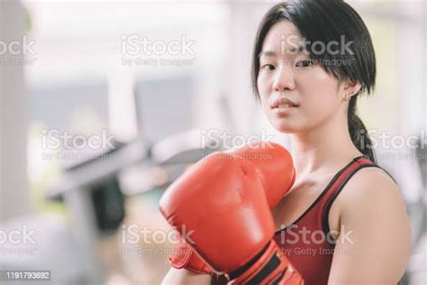 An Asian Chinese Female Teenager Athlete Wearing Boxing Gloves Workout