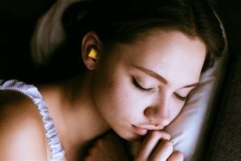Premium Photo Woman Sleeping With Ear Plugs In Her Ears