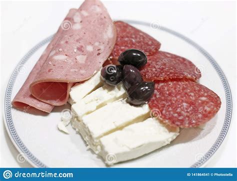 Plate With Cold Cuts Salami And Ham Olive Oils And White Cheese