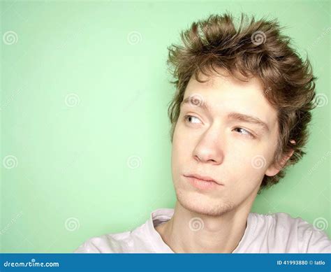 Close Up Portrait Of Young Man Thinking And Looking Away Left Stock