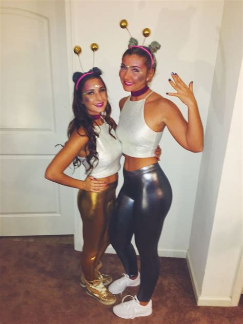 Two Women Dressed In Costumes Standing Next To Each Other With Their Hands On Their Hipss