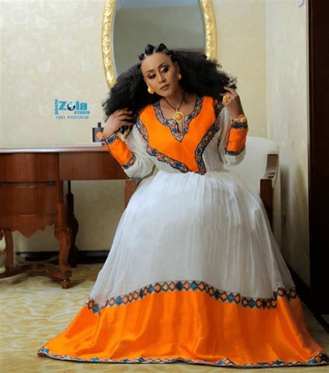 Clipkulture Lady In Beautiful Orange And White Patterned Habesha Kemis Gold Jewelry And