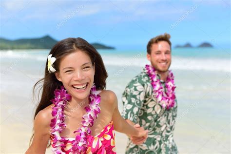 Couple Wearing Hawaiian Flower Leis Stock Photo By ©maridav 72654177