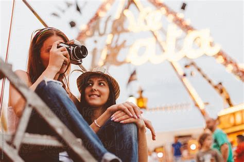 Two Woman Have Fun And Take Photos At Amusement Park By Stocksy Contributor Alexandra Bergam
