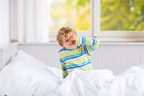 Carefree Little Kid Boy Sleeping In Bed In Colorful Nightwear Stock