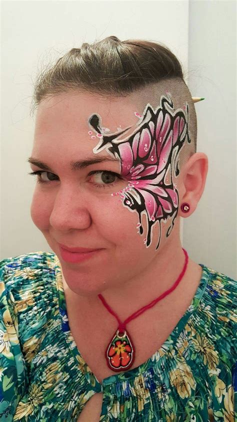 A Woman With Her Face Painted Like A Butterfly