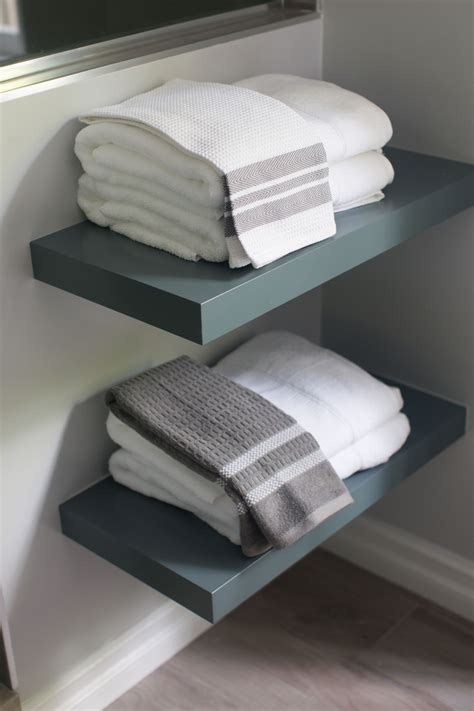 Three Shelves With Towels Stacked On Top Of Each Other
